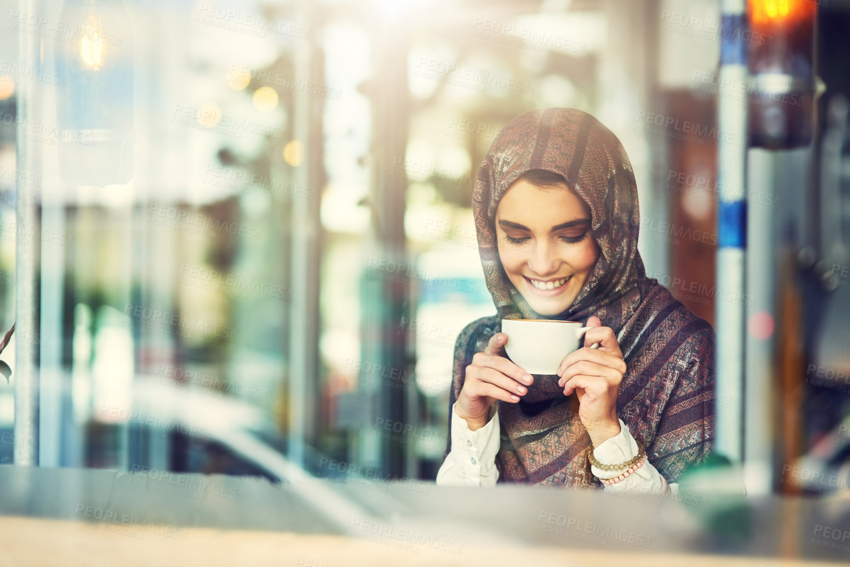 Buy stock photo Shot of a young woman having a cup of coffee in a cafe