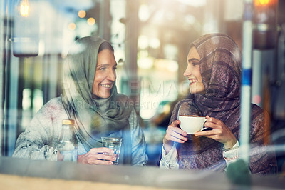 Buy stock photo Shot of two women chatting over coffee in a cafe