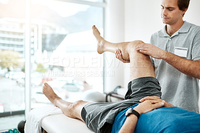 Buy stock photo Man, knee pain and physiotherapist working in consulting room, rehabilitation with exercise. Male people, office and together for physiotherapy service with health insurance or osteoporosis support