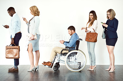 Buy stock photo Studio shot of a group o focused people standing in row behind each other against a white background