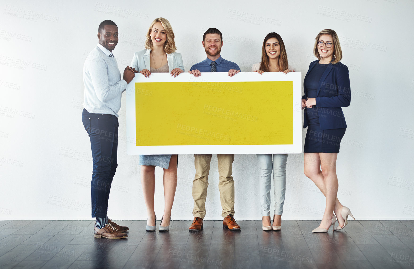 Buy stock photo Studio shot of a group of businesspeople holding up a blank yellow placard