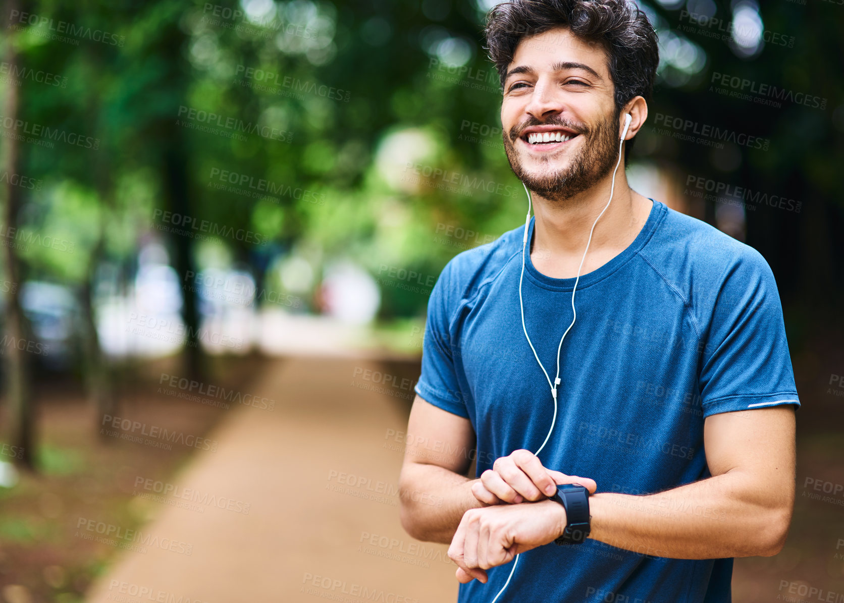 Buy stock photo Fitness, music and man with a watch for time, running progress and heart results in a park. Smile, thinking and a male athlete listening to a podcast or audio while checking notification on a device