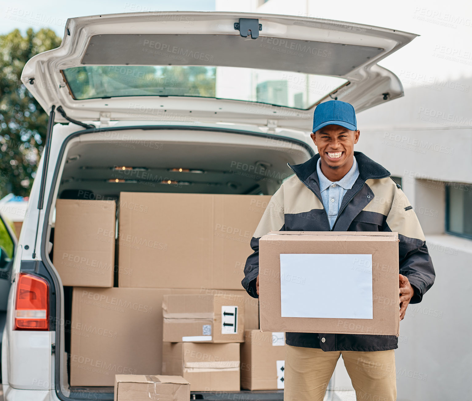 Buy stock photo Portrait of a courier unloading boxes from a delivery van