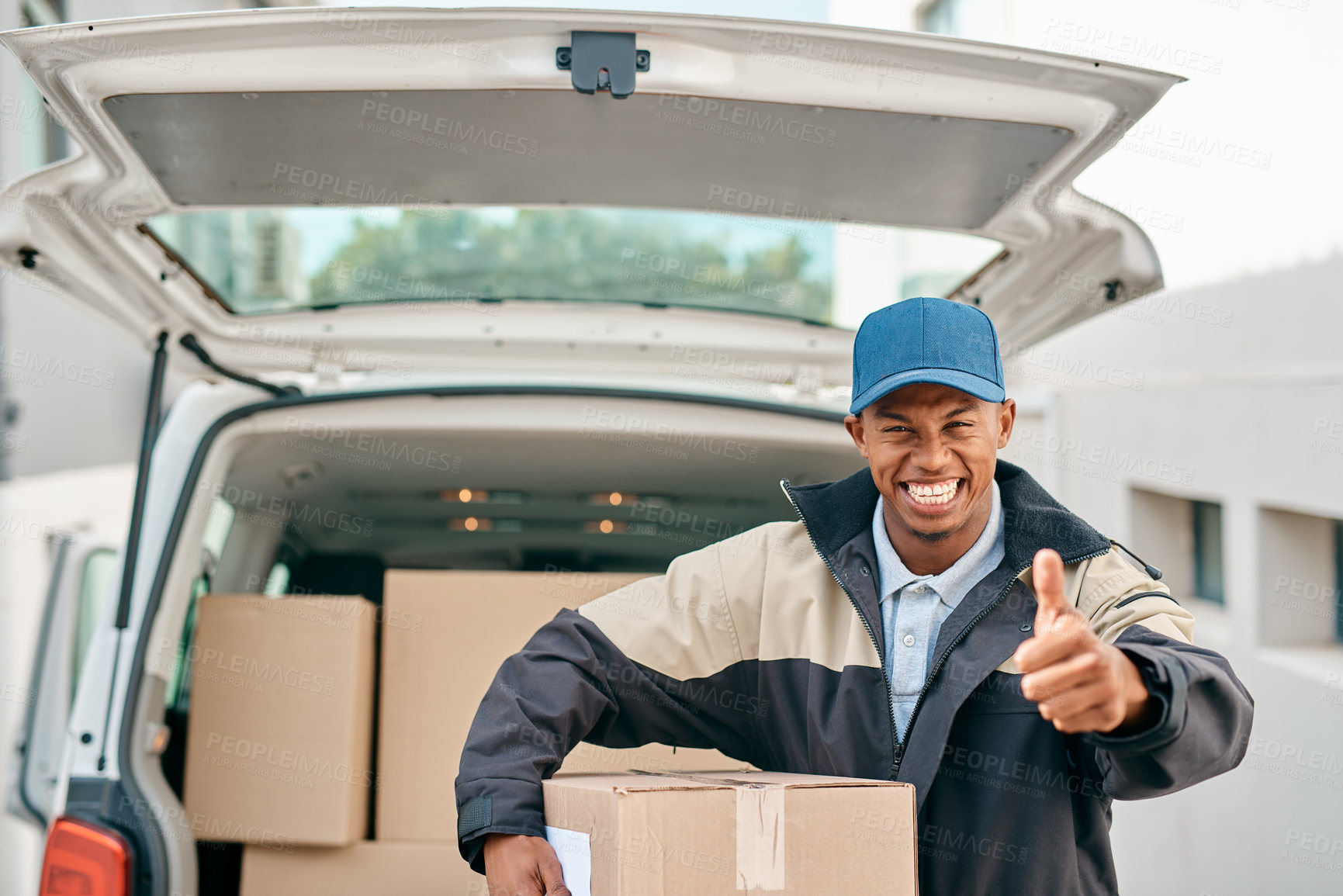 Buy stock photo Portrait of a courier showing thumbs up while unloading boxes from a delivery van