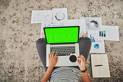 Buy stock photo High angle shot of an unrecognizable woman working on a laptop while drinking coffee on the floor at home