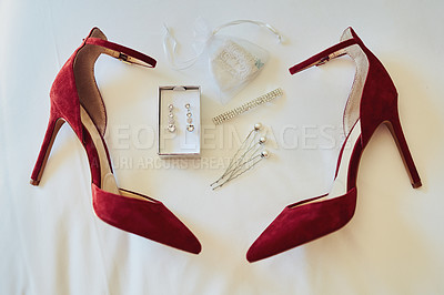 Buy stock photo Closeup of various amounts of fine elegant jewelry and a pair of red high heels resting against a white sheet
