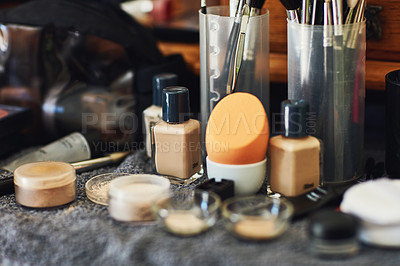 Buy stock photo Shot of a numerous amount of different types of makeup laid out on top of a table