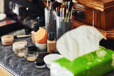 Buy stock photo Shot of a numerous amount of different types of makeup laid out on top of a table