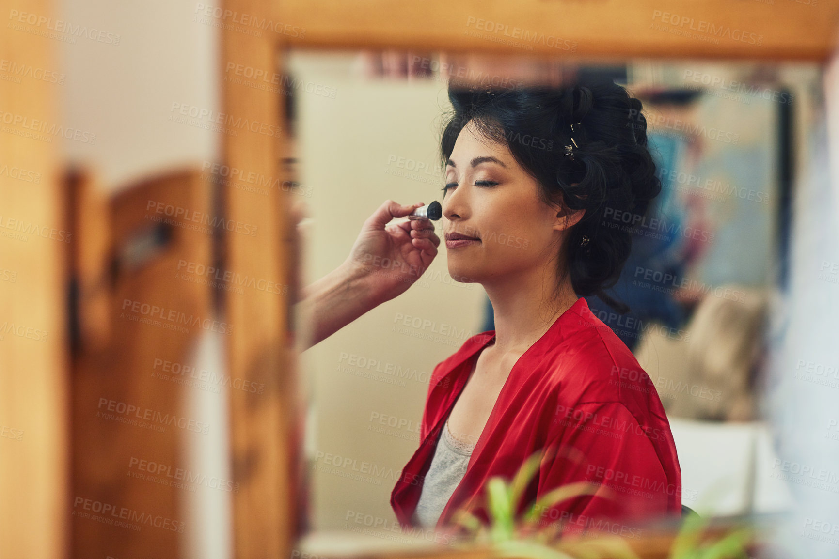 Buy stock photo Woman, bride and apply blush in mirror, people assisting and cosmetics application for wedding event. Morning, elegant makeup and get ready for ceremony, beauty and home routine with reflection
