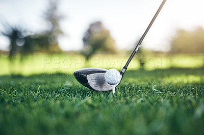 Buy stock photo Closeup shot of a golf ball on top of a golf peg with a golf club next to it about to hit it outside during the day