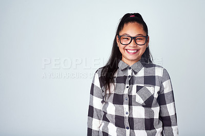 Buy stock photo Studio portrait of a cute and confident young girl posing against a gray background