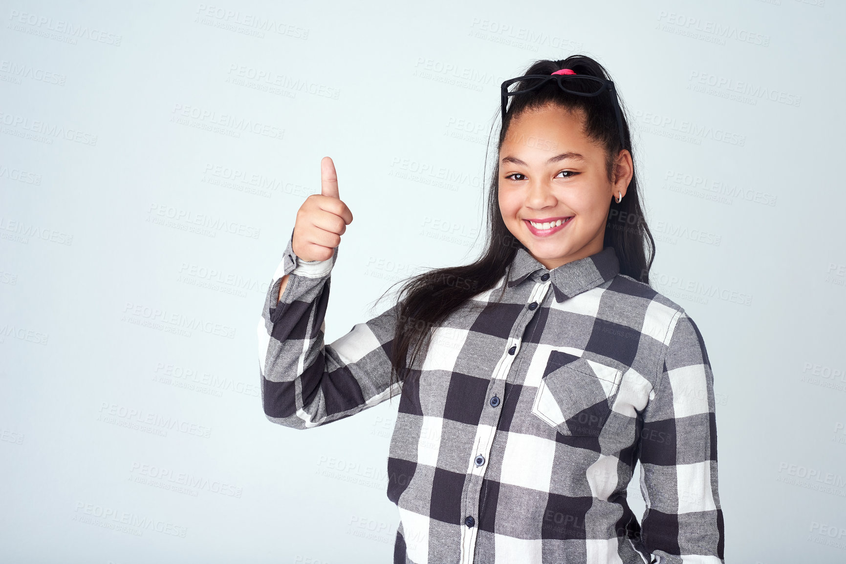 Buy stock photo Child, portrait and girl in studio with thumbs up for opinion, agreement and yes in mockup space. Happy, student and thank you emoji for support on project in school with feedback, review and vote 