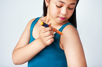 Buy stock photo Medicine, girl and insulin shot in studio for blood sugar levels, glucose or energy for body. Young person, child and injection for wellness in white background, diabetes or medical treatment for kid