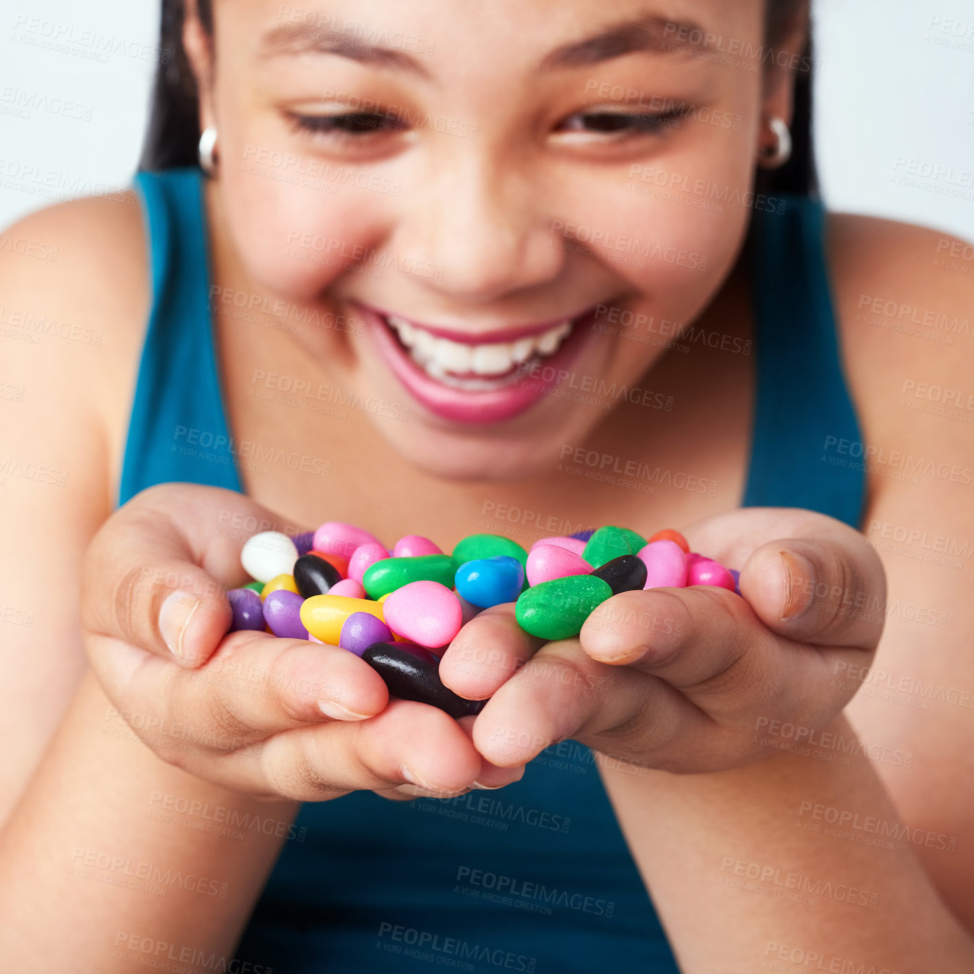 Buy stock photo Girl, candy or excited at win, motivation or success of growth, surprise or gratitude in closeup. Female child, hand or jelly beans to smile, thinking or treasure of reward at achievement in studio