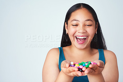 Buy stock photo Child, candy or smile at wow, win or motivation for success, growth mindset or gratitude at dream. Excited, girl or hand of jelly beans to omg, thinking or treasure of reward at achievement in studio