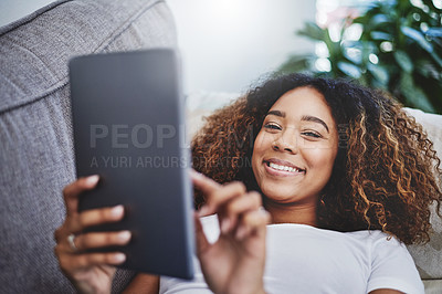 Buy stock photo Portrait of an attractive young woman using a digital tablet at home