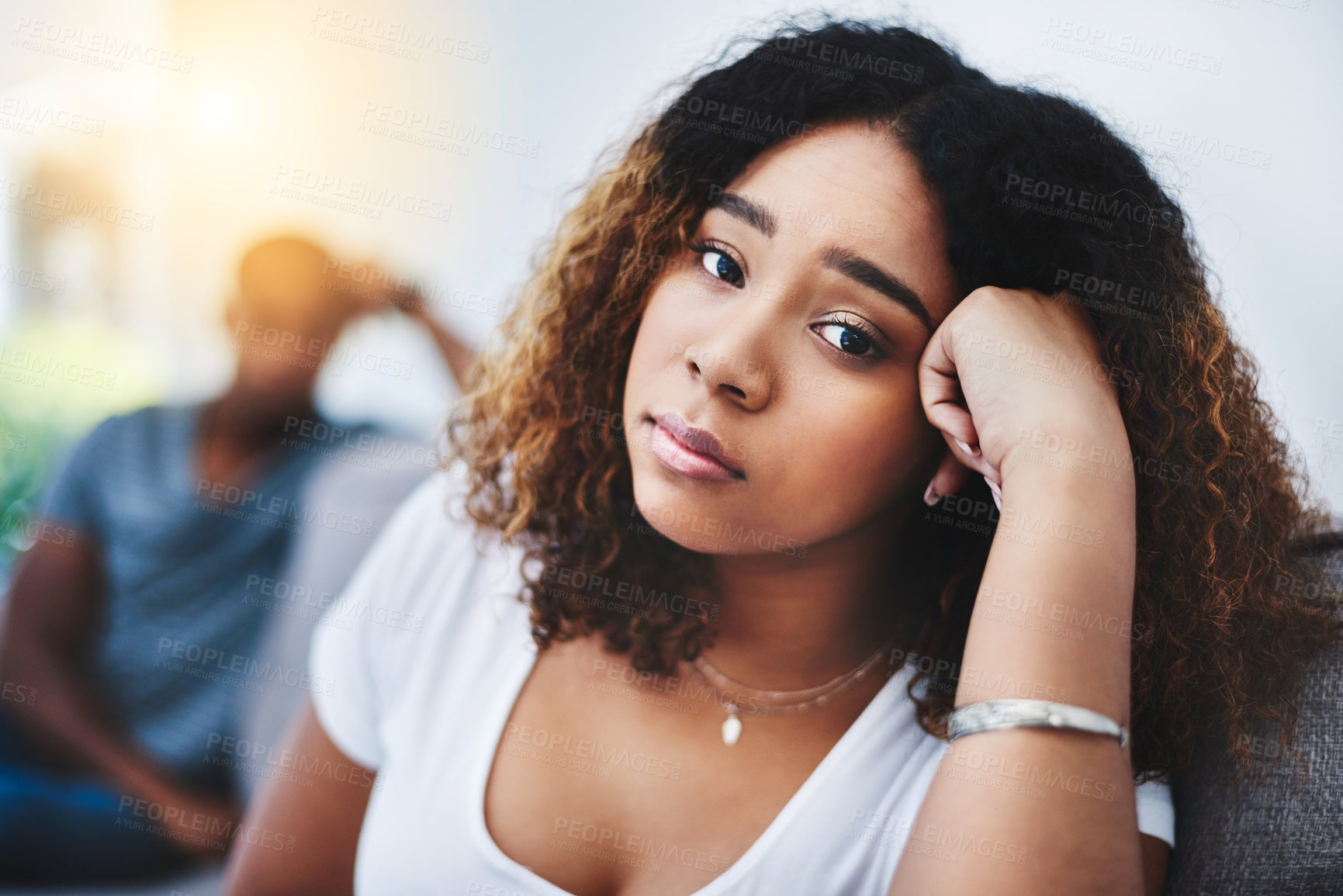Buy stock photo Portrait of a young woman looking despondent after having a fight with her partner at home