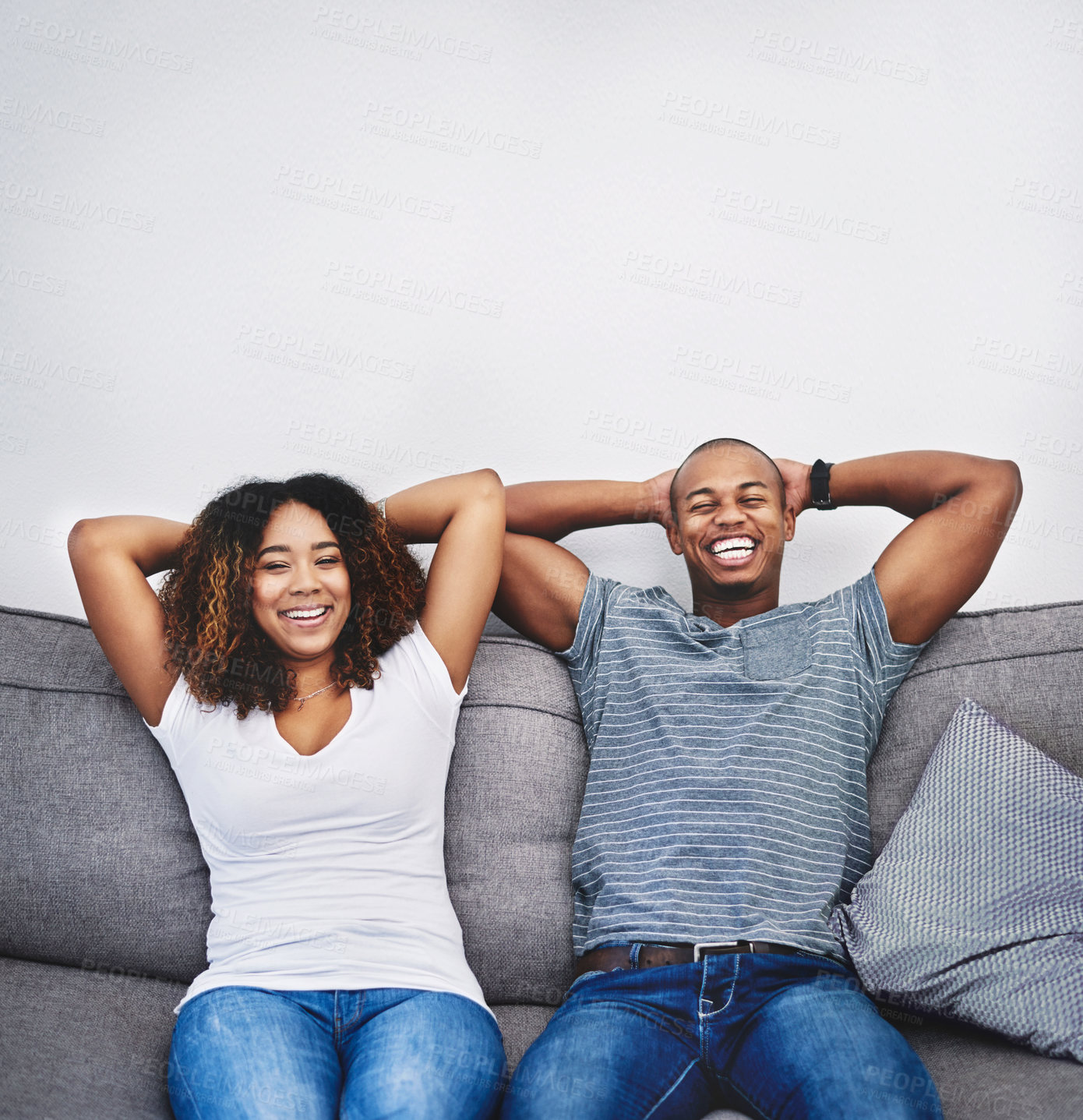 Buy stock photo Portrait of a young couple relaxing together at home