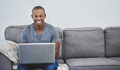 Buy stock photo Portrait of a handsome young man using a laptop at home