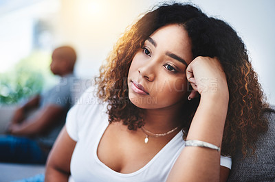 Buy stock photo Shot of a young woman looking despondent after having a fight with her partner at home