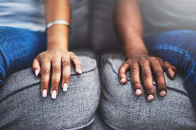 Buy stock photo Closeup shot of an unrecognizable couple with their hands alongside each other on a couch