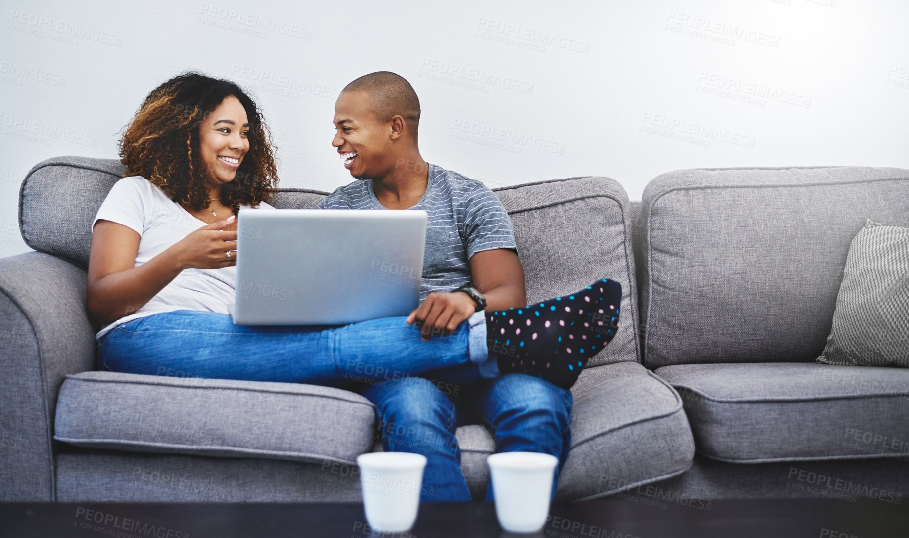 Buy stock photo Laugh, relax and black couple on laptop on sofa online for social media, streaming movies and internet. Dating, home and man and woman with computer for bonding, relationship and chill on weekend