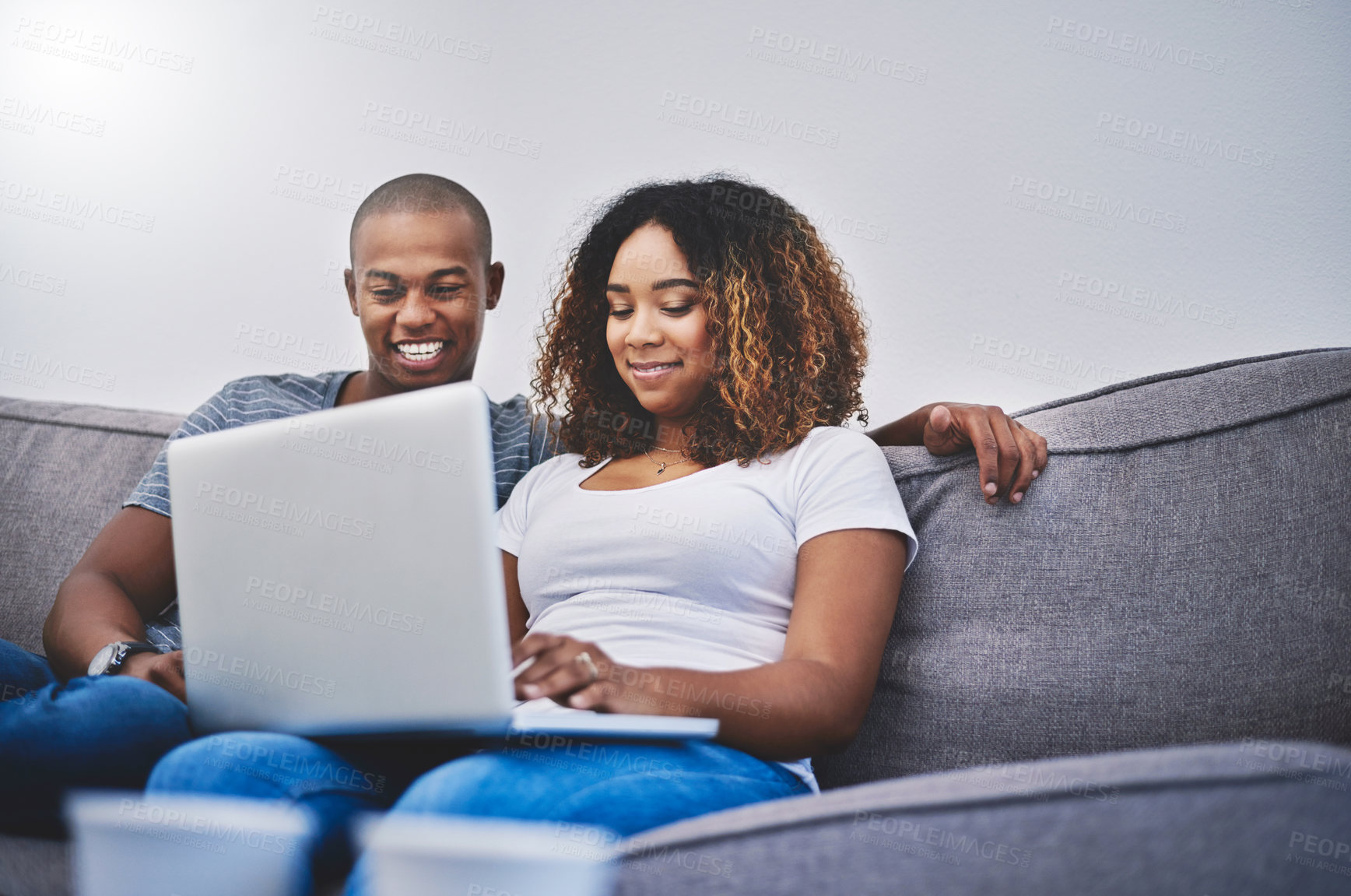 Buy stock photo Happy, relax and couple on laptop on sofa online for social media, streaming movies and internet. Dating, home and African man and woman with computer for bonding, relationship and chill on weekend