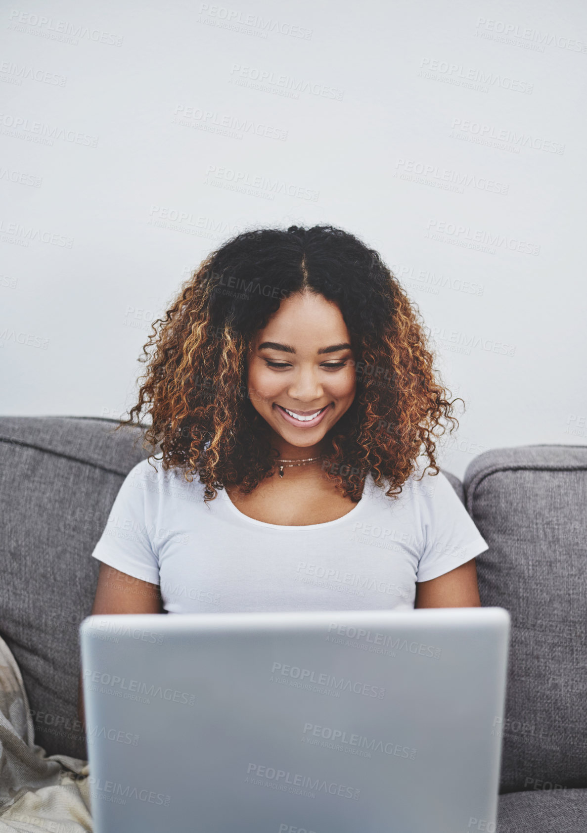 Buy stock photo Sofa, laptop and happy black woman networking for online research, freelance project and smile in home. Relax, remote work and girl reading good news email on couch with computer for web subscription