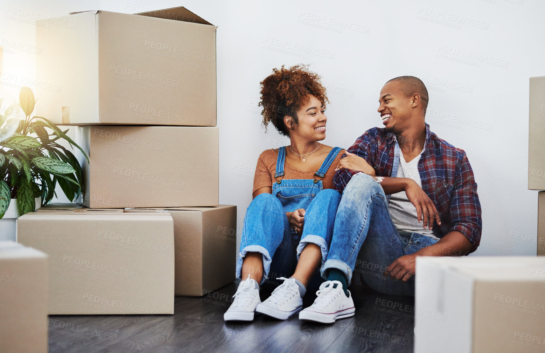 Buy stock photo Shot of an attractive young couple moving house