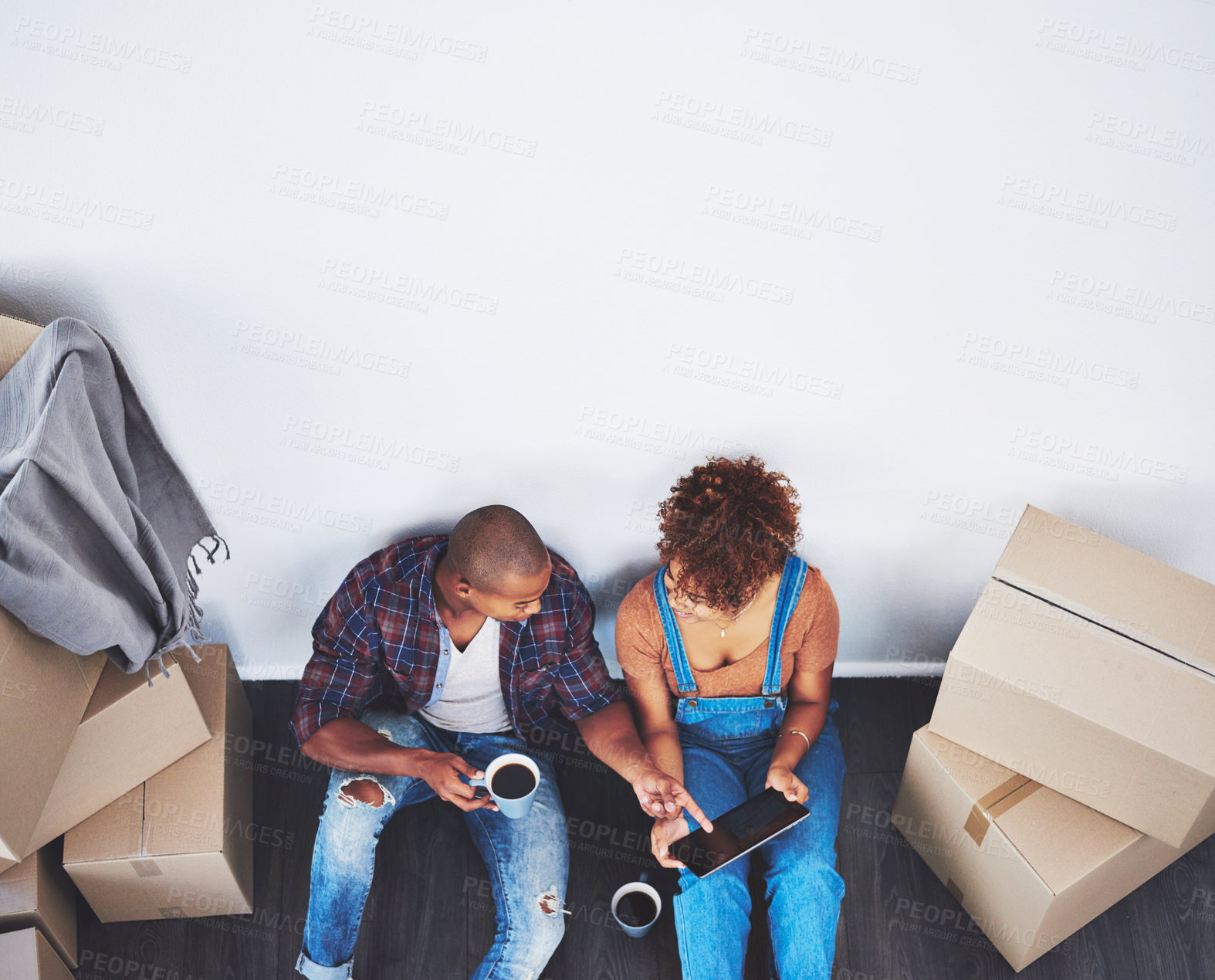 Buy stock photo Shot of an attractive young couple moving house