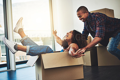 Buy stock photo Shot of an attractive young couple moving house