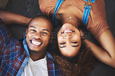 Buy stock photo Happy, portrait and couple relax on house floor with support, trust or bonding in top view home. Face, smile or people in living room with love, safety and security, resting and chilling in apartment