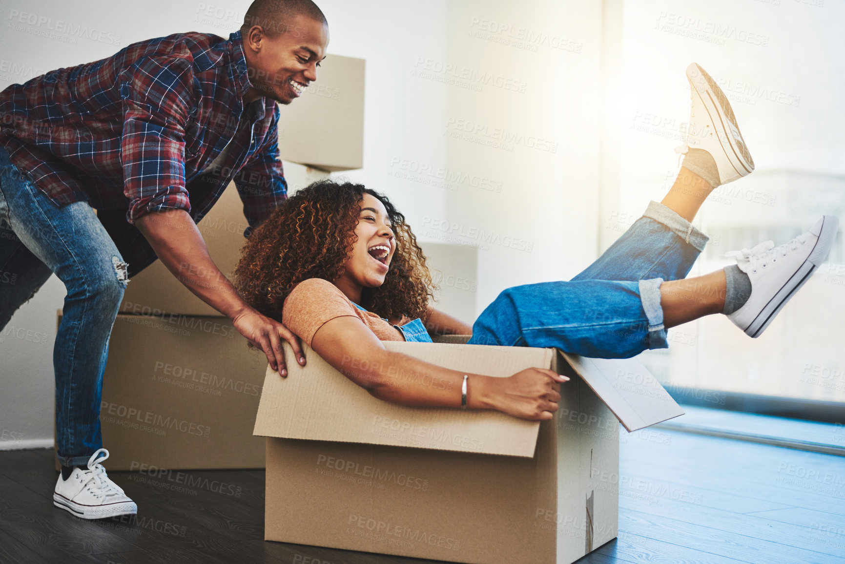 Buy stock photo Shot of an attractive young couple moving house