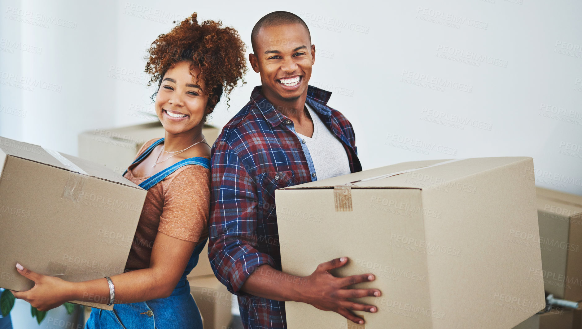 Buy stock photo Shot of an attractive young couple moving house