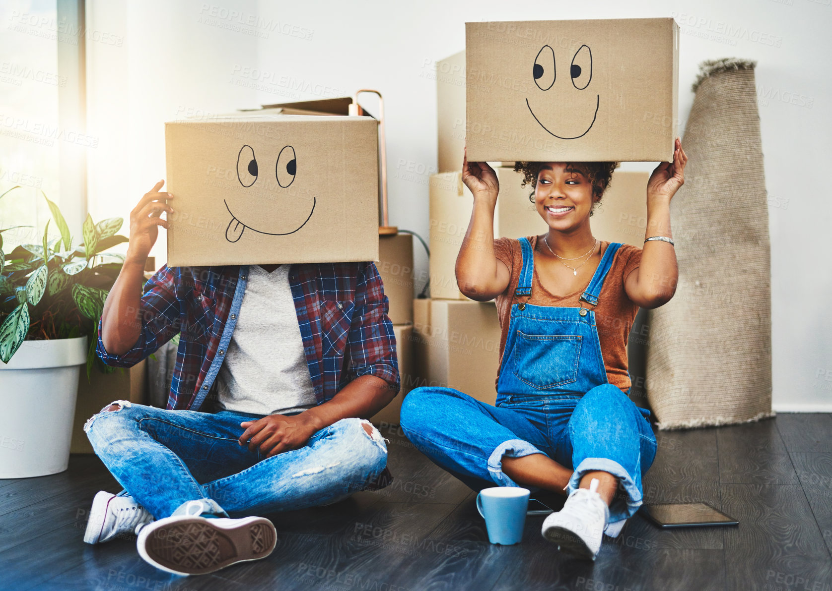 Buy stock photo Shot of a young couple moving house