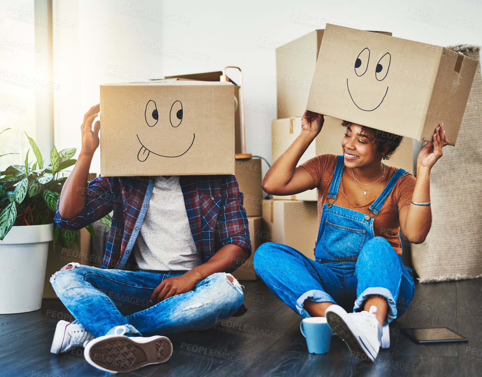 Buy stock photo Shot of a young couple moving house