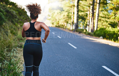 Buy stock photo Woman, back view and running with road for fitness, workout or outdoor exercise in nature. Active female person, athlete or young runner on street for training, cardio or health and wellness outside