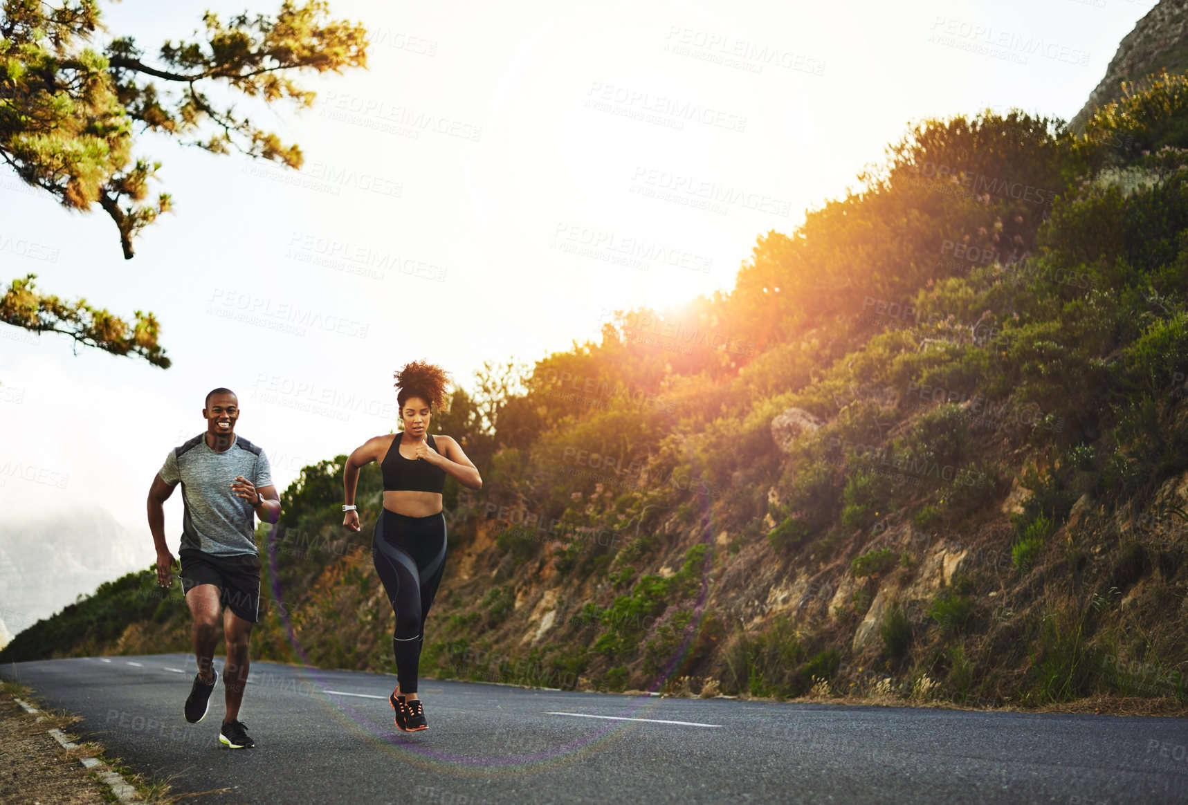Buy stock photo Shot of a young couple out running together