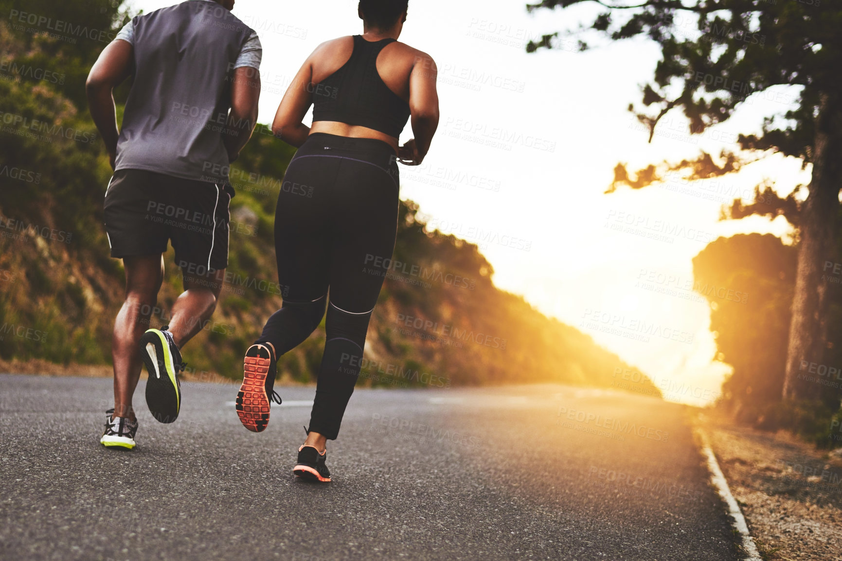 Buy stock photo Couple, back and running with sunset on road for workout, training or outdoor exercise together in nature. Rear view of man, woman or runners for cardio fitness, sprint or race on asphalt street