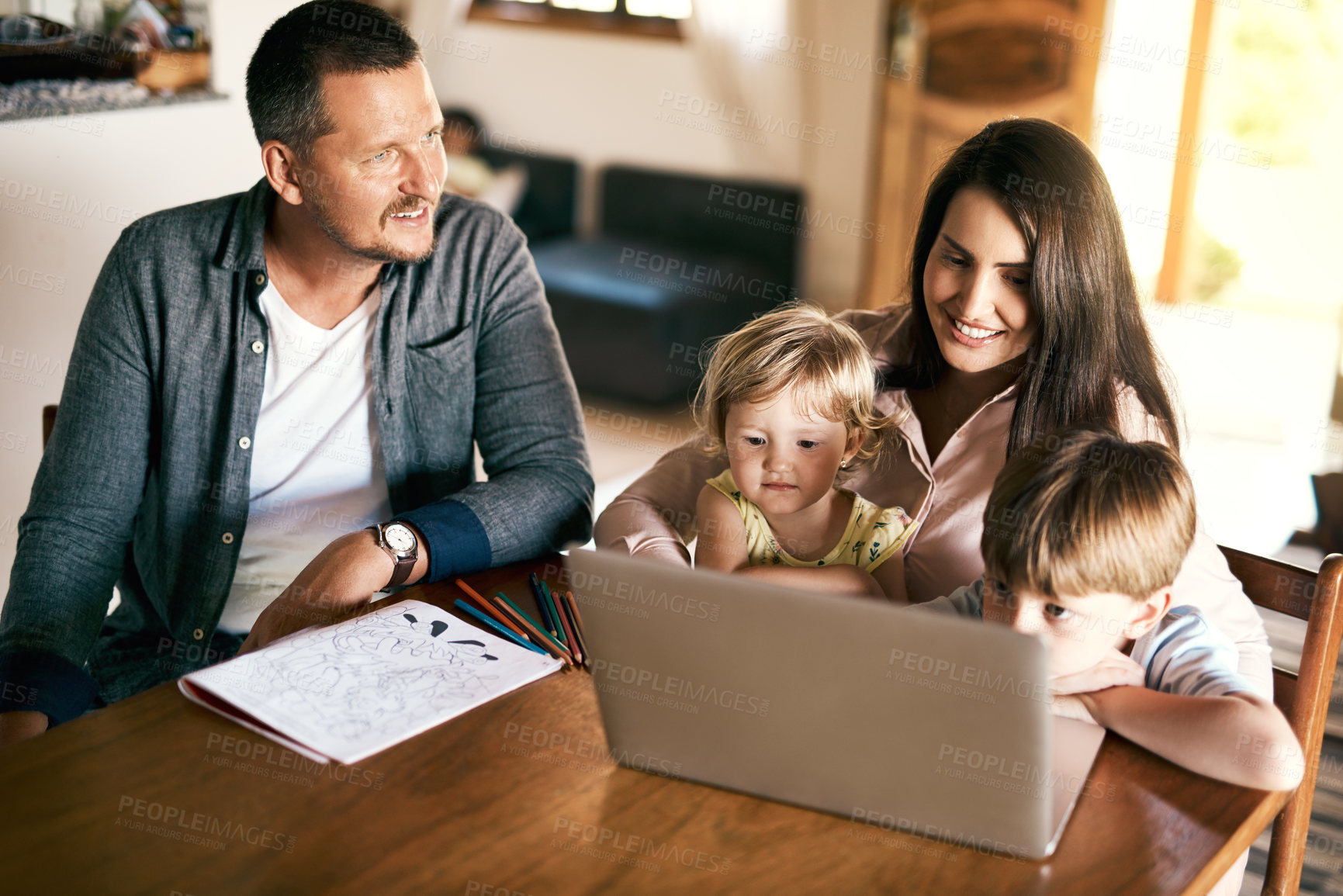 Buy stock photo Shot of an adorable brother and sister using a laptop with their mother at home