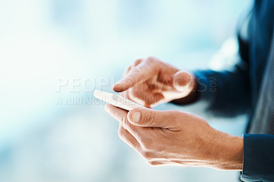 Buy stock photo Cropped shot of an unrecognizable businessman sending a text message