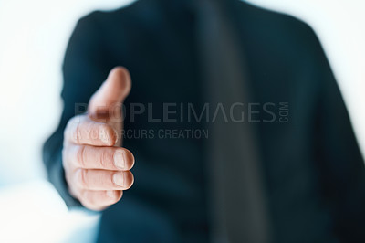 Buy stock photo Cropped shot of an unrecognizable businessman reaching out for a handshake