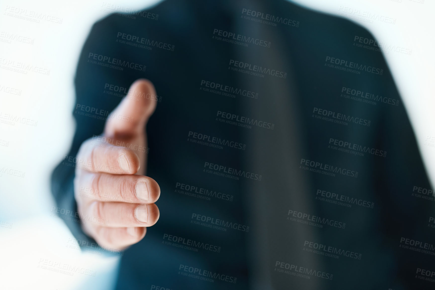 Buy stock photo Cropped shot of an unrecognizable businessman reaching out for a handshake