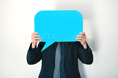 Buy stock photo Cropped shot of an unrecognizable businessman holding a speech bubble up in front of his face