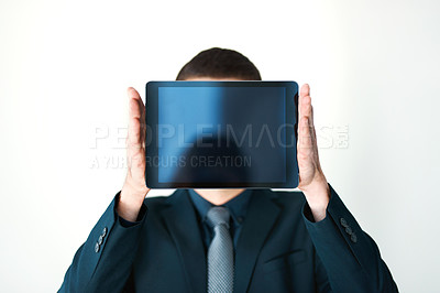 Buy stock photo Cropped shot of an unrecognizable businessman holding a digital tablet up in front of his face
