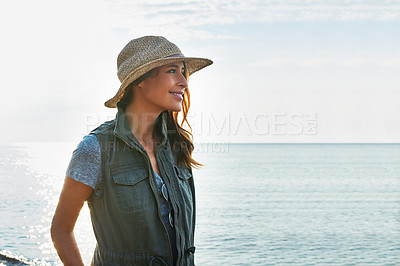 Buy stock photo Shot of an attractive young woman enjoying a walk by the lake