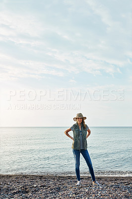 Buy stock photo Shot of an attractive young woman enjoying a walk by the lake