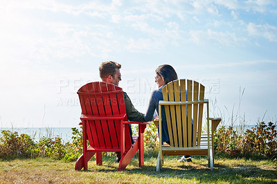 Buy stock photo Rearview shot of a married couple enjoying a day at the lake