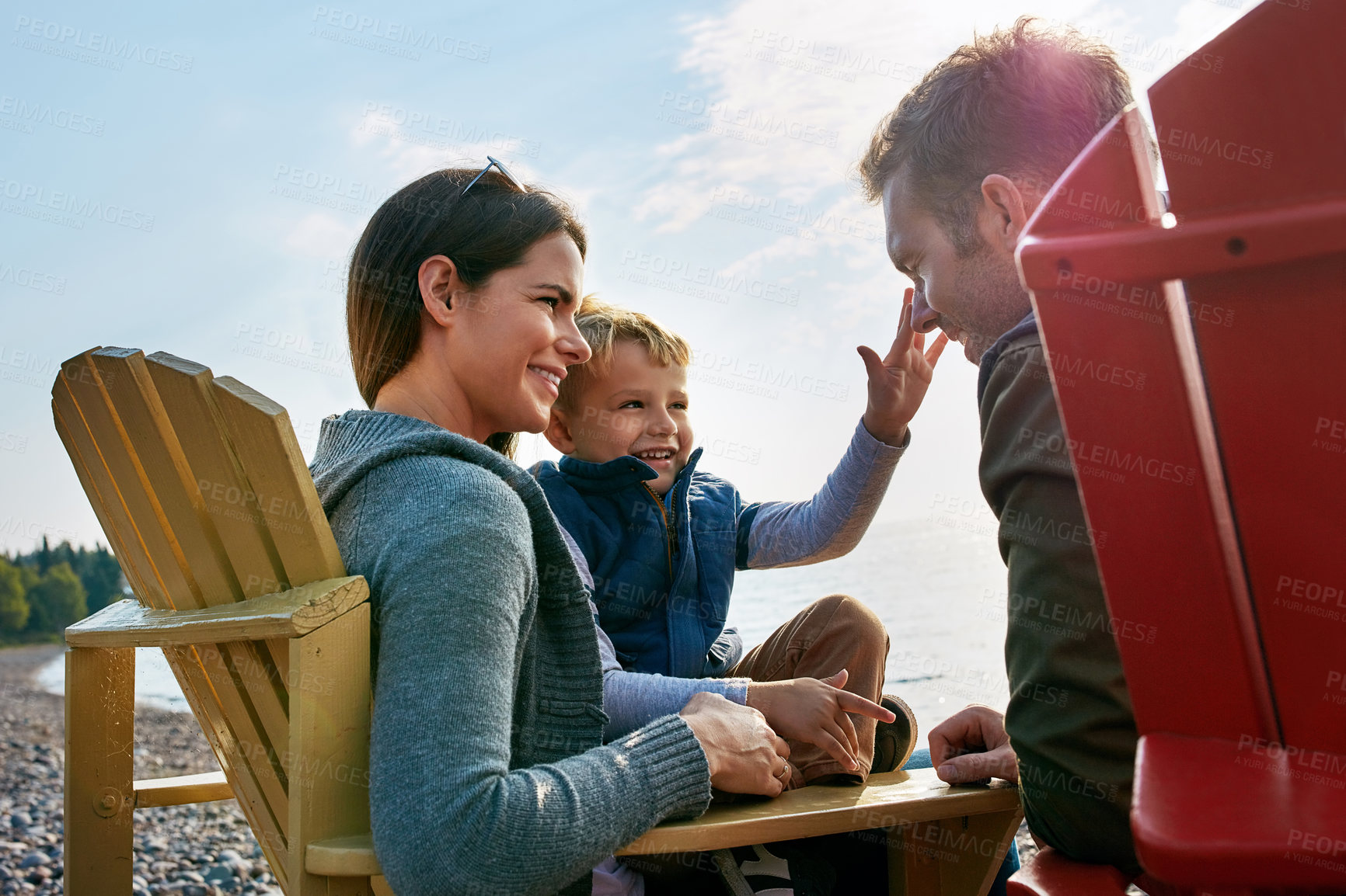 Buy stock photo Shot of a young family spending a day at the lake
