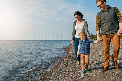 Buy stock photo Shot of a young family spending a day at the lake